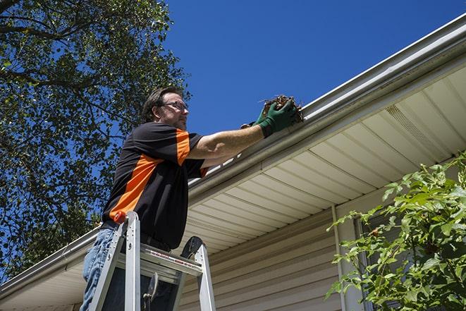 fixing a leaky gutter with new screws and brackets in Arendtsville